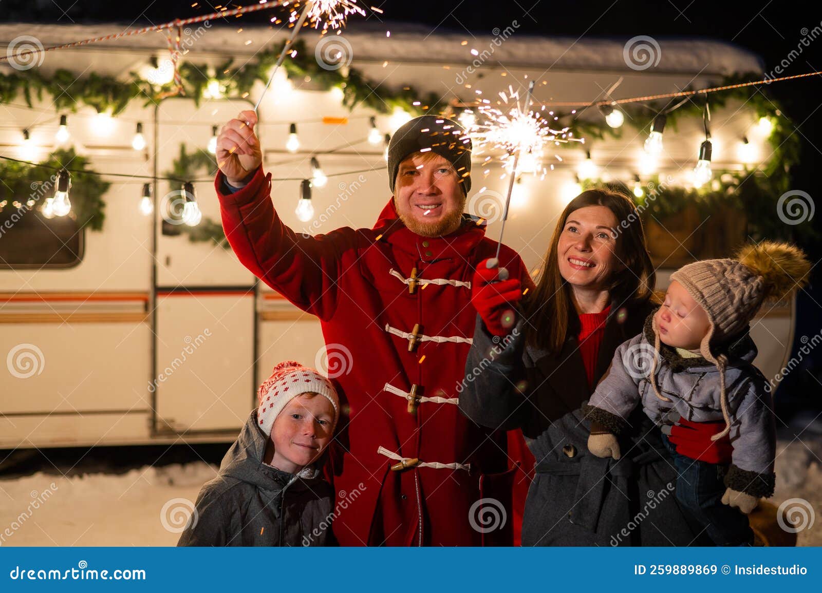 Happy Family Celebrates Christmas In Nature And Holds Sparklers happy-family-celebrates-christmas-in-nature-and-holds-sparklers