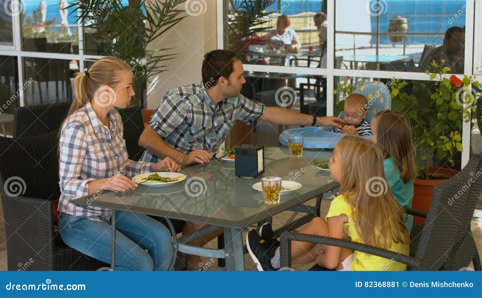 Happy Family with Children Having Lunch in a Cafe Stock Image - Image