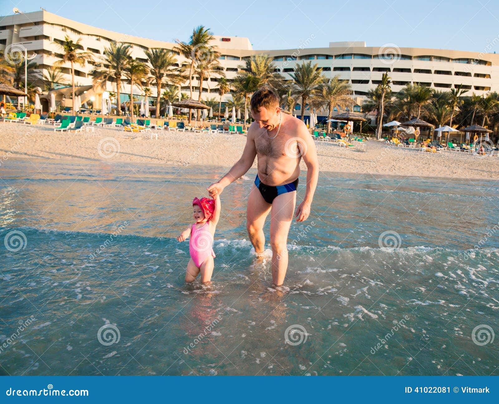 happy family: dad and child on beach in persian gulf ,dubai