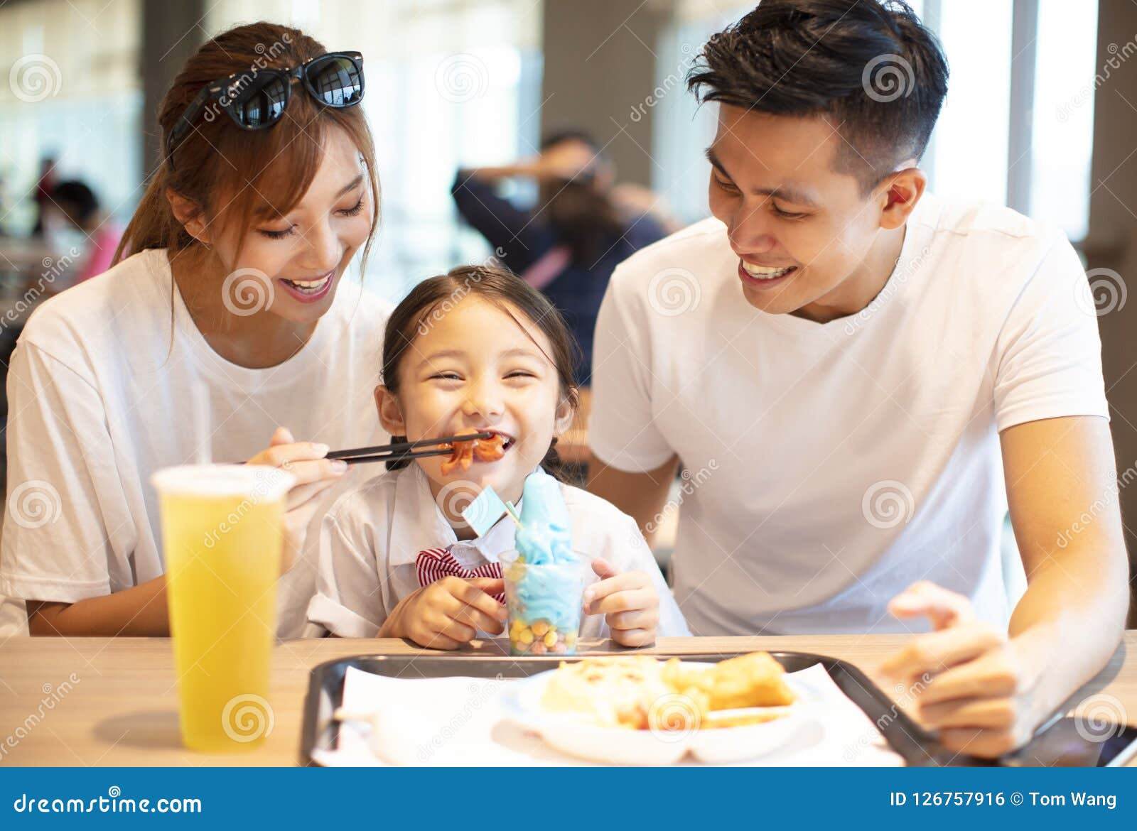 Happy Family Enjoying Dinner in Restaurant. Stock Photo - Image of