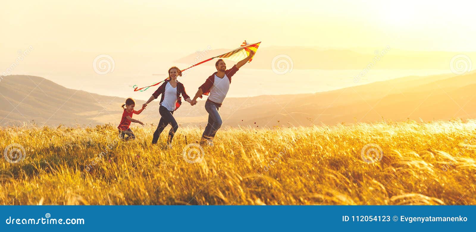 happy family father, mother and child daughter launch a kite on