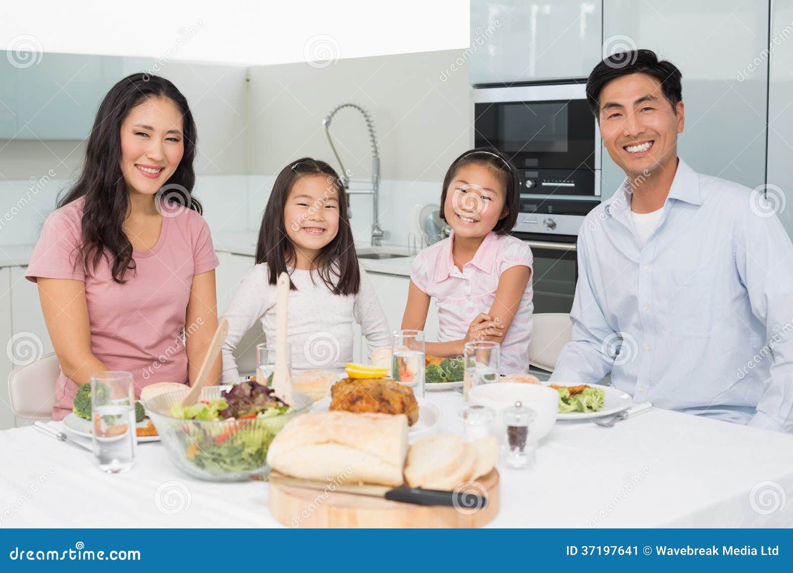 Happy Family of Four Enjoying Healthy Meal in Kitchen Stock Image ...