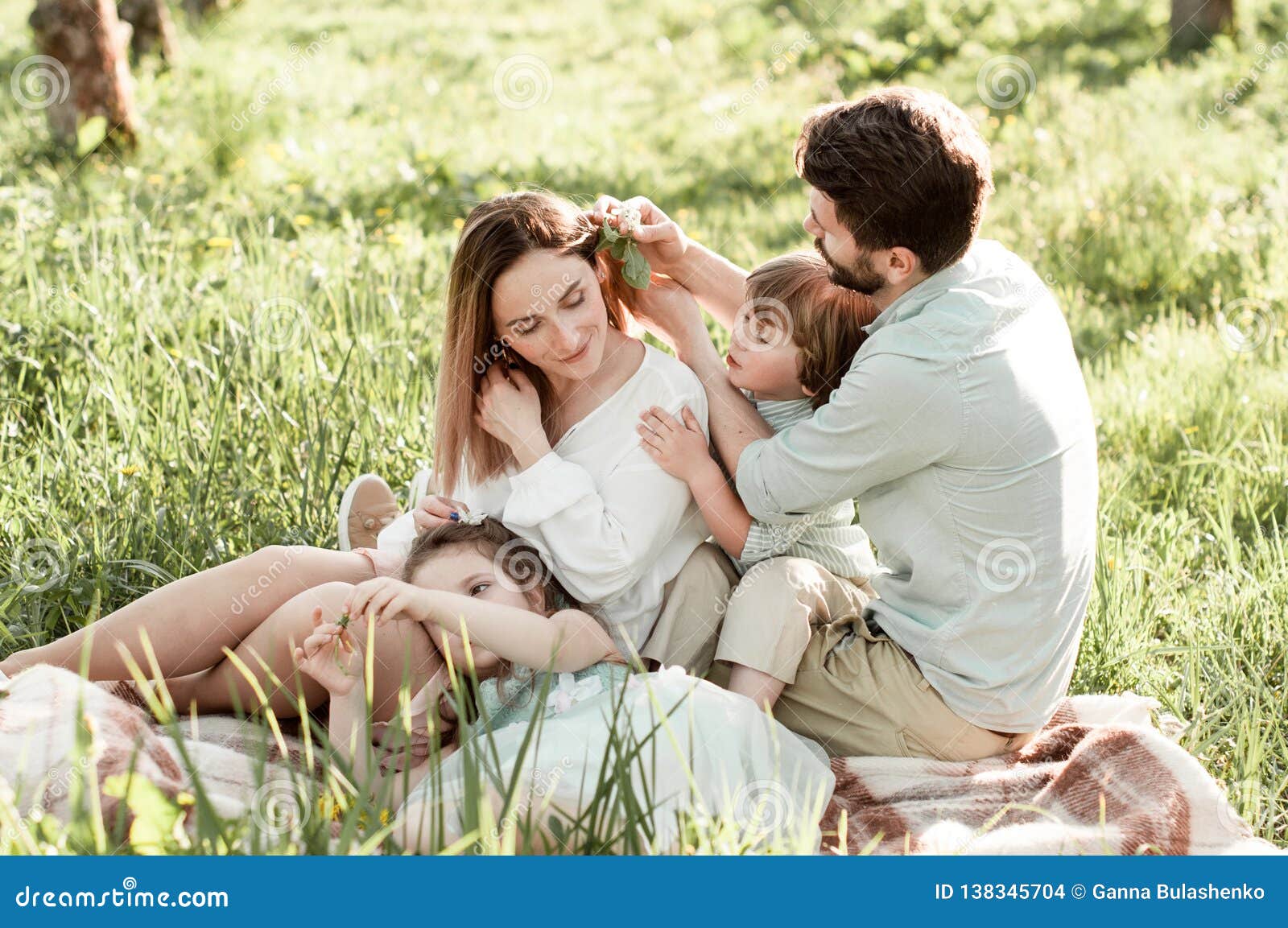 Happy family in a garden stock photo. Image of lovely - 138345704