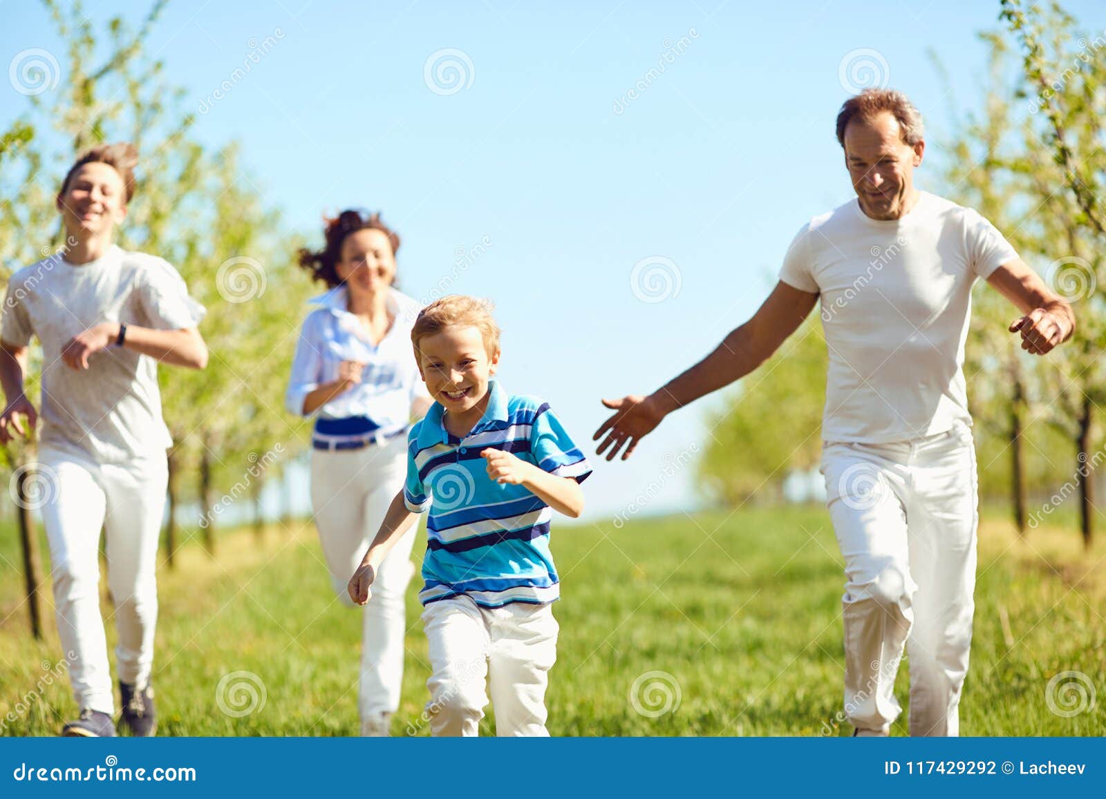 Happy Family Having Fun Walking in the Garden in Spring, Summer. Stock