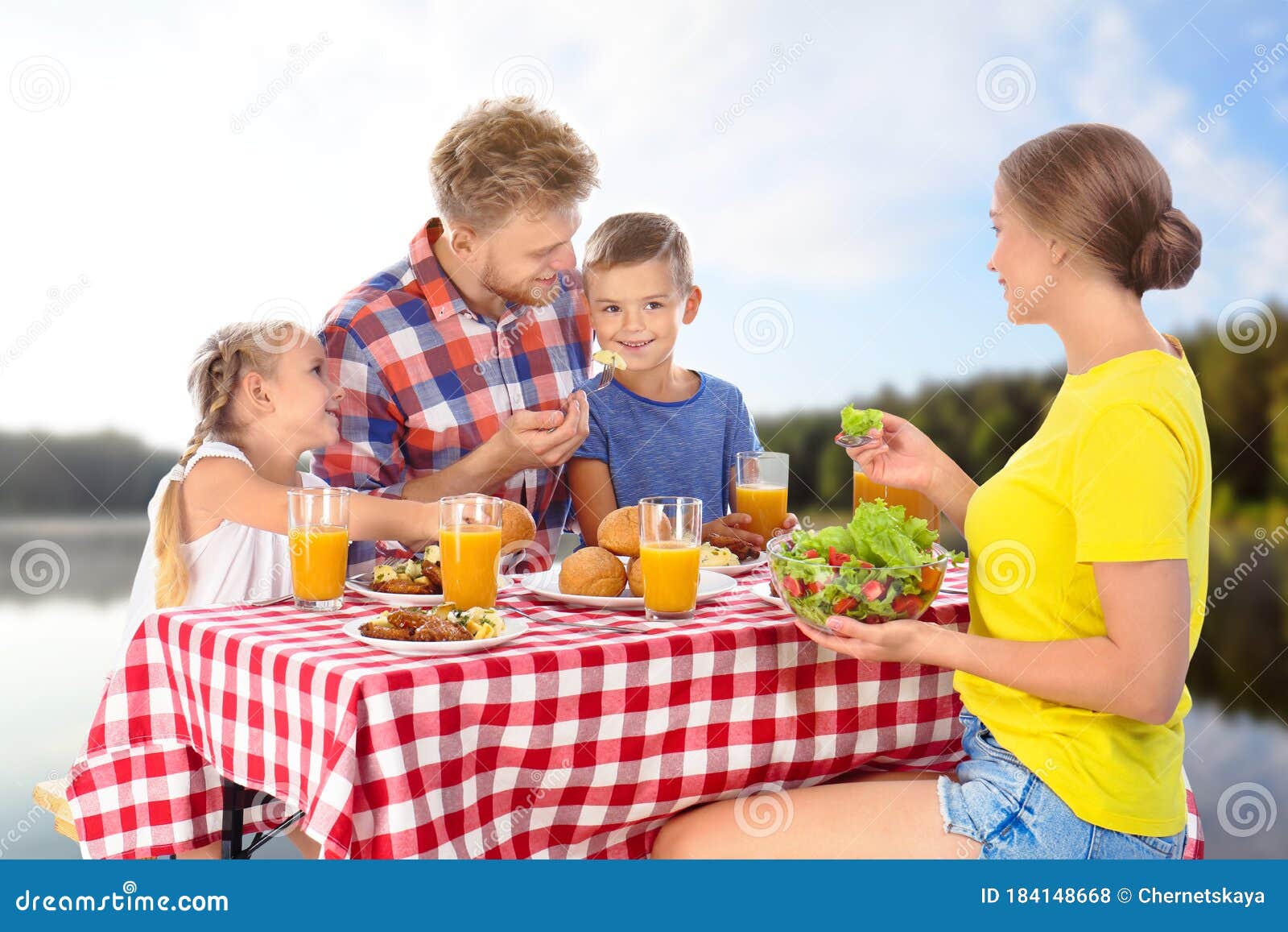 Family Having Picnic at Table in Park Stock Photo Image of forest