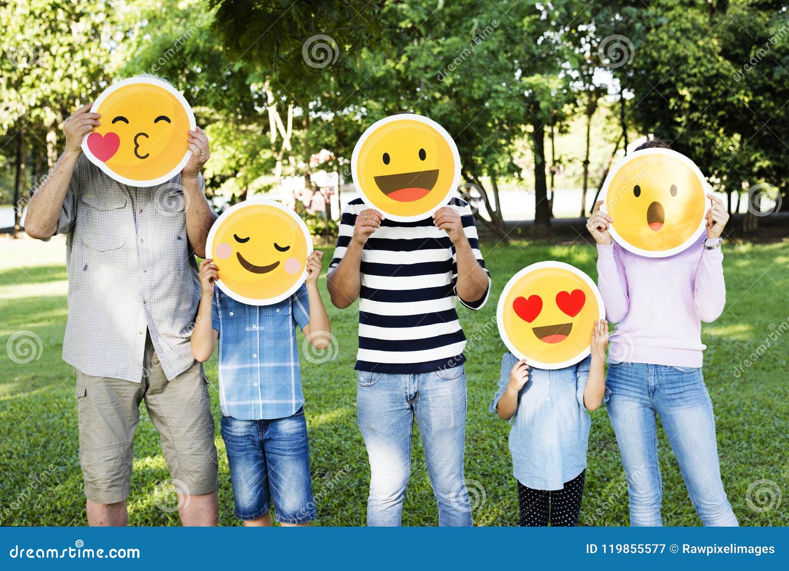 happy family holding up emojis