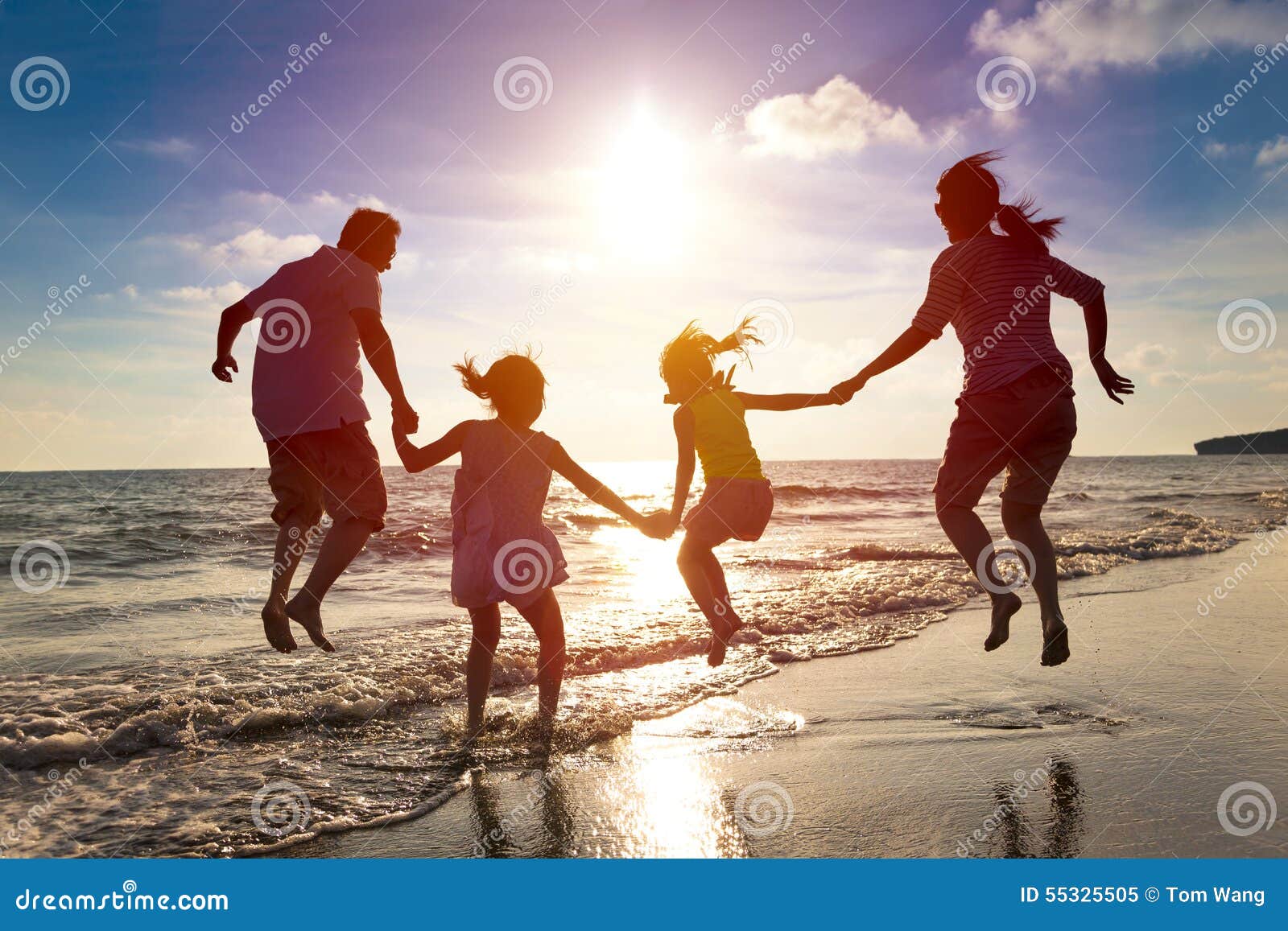 happy family jumping on the beach