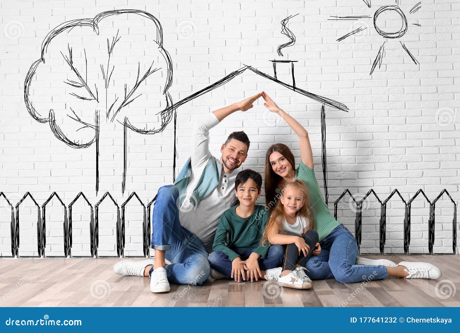 happy family with kids dreaming about house. s on brick wall