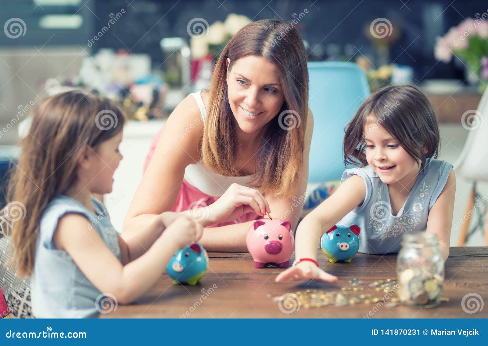 happy family mom daughter save money piggy bank future investment savings