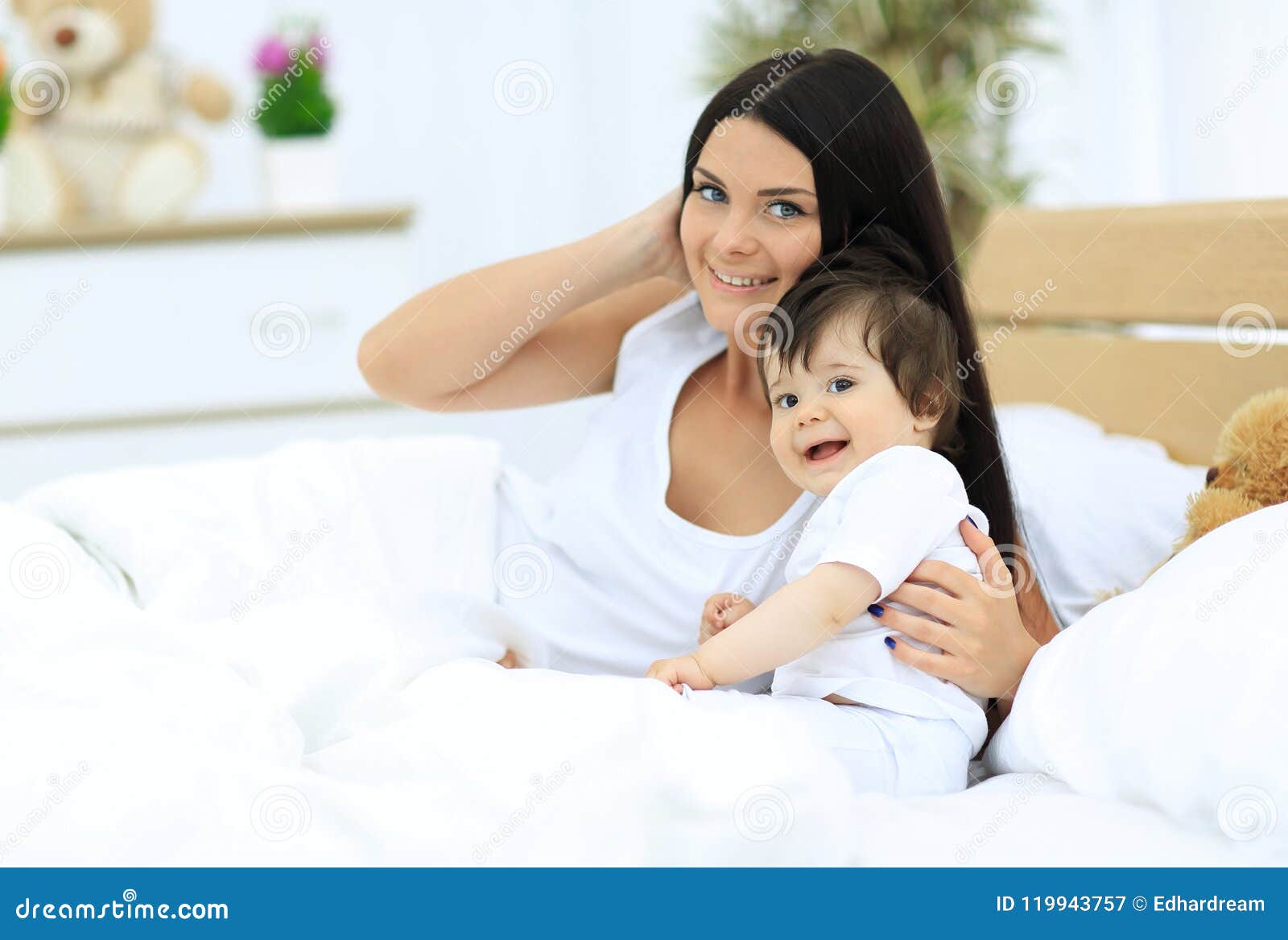 Portrait of a Beautiful Mother with Her Baby in the Bedroom Stock Image ...