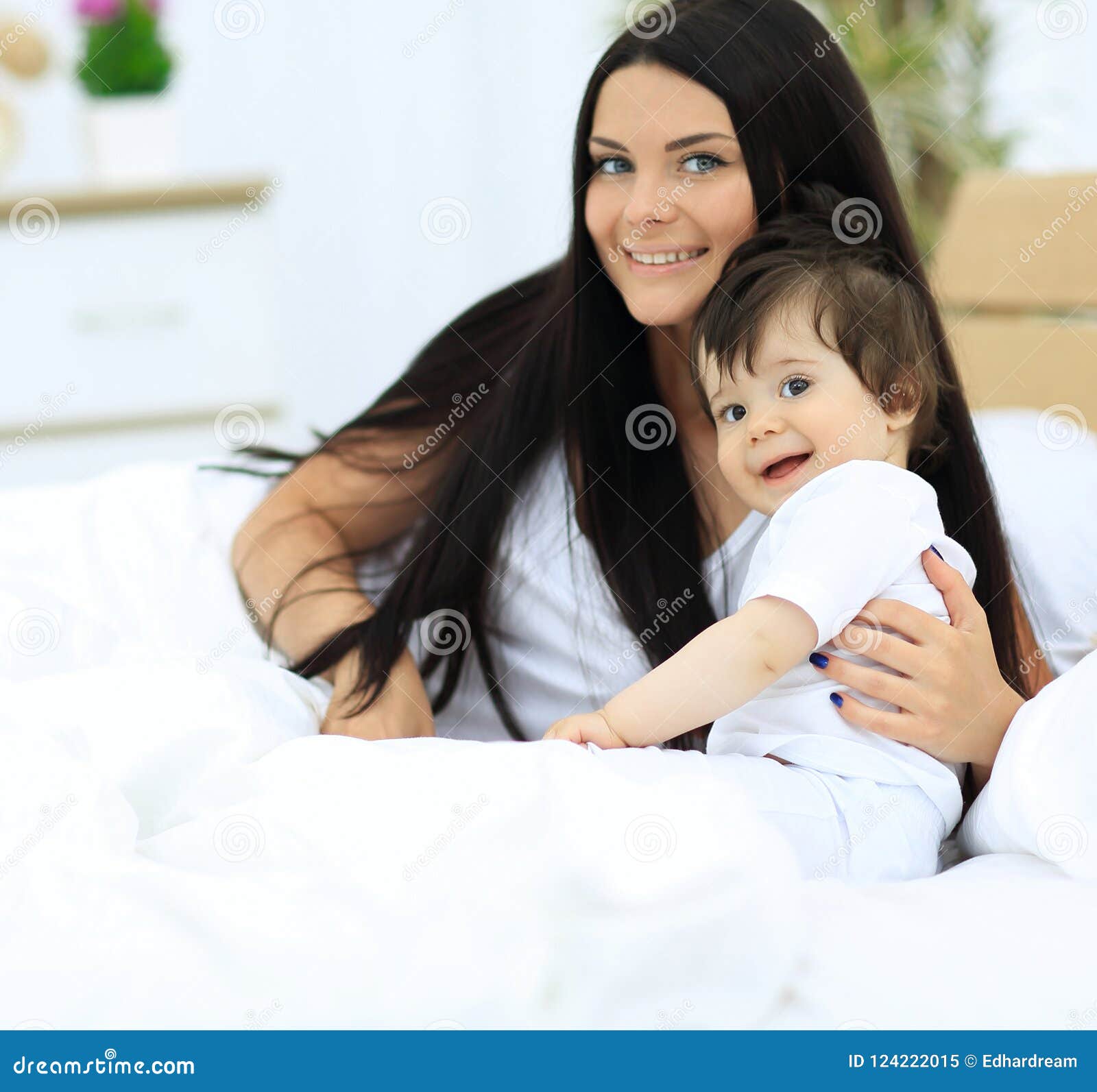 Portrait of a Beautiful Mother with Her Baby in the Bedroom Stock Image ...