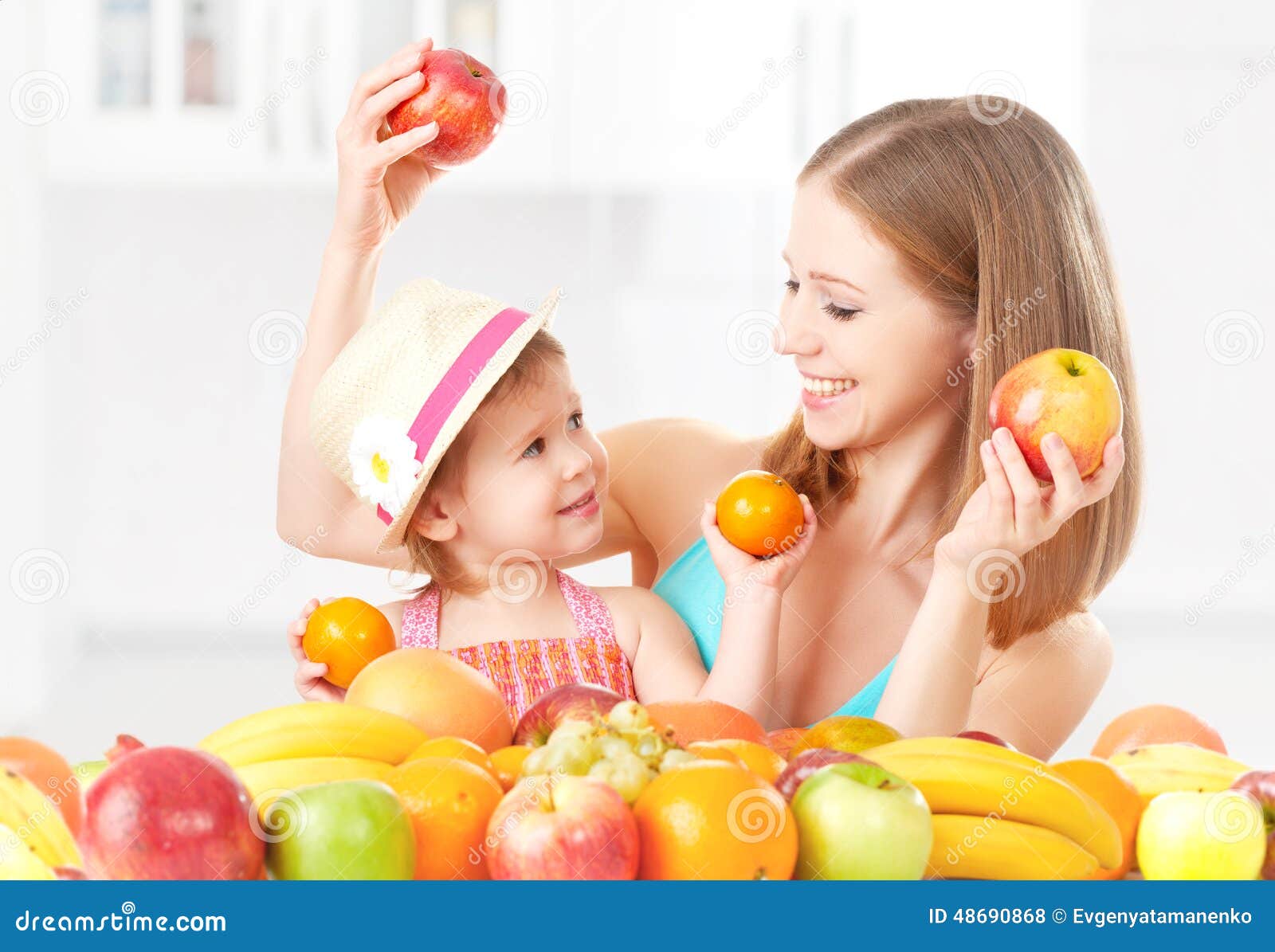 happy family mother and daughter little girl, eat healthy vegetarian food, fruit