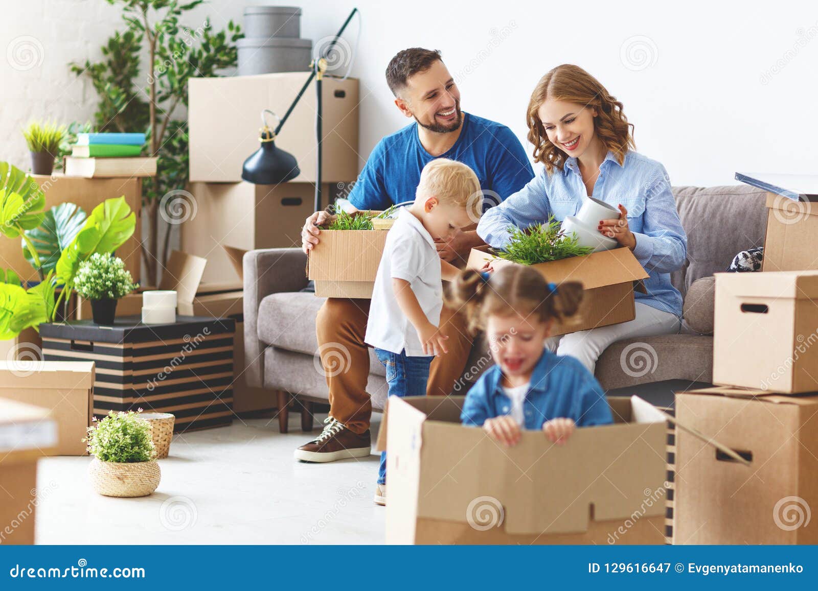 happy family mother father and children move to new apartment an