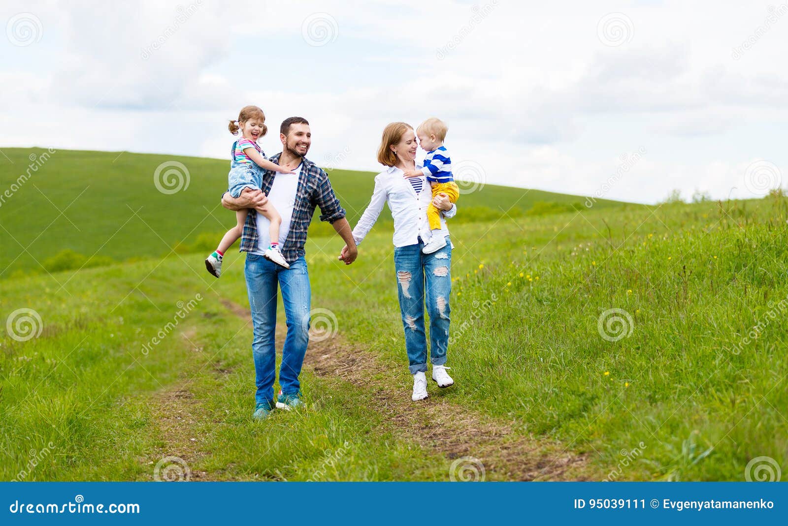 happy family: mother, father, children son and daughter on summer