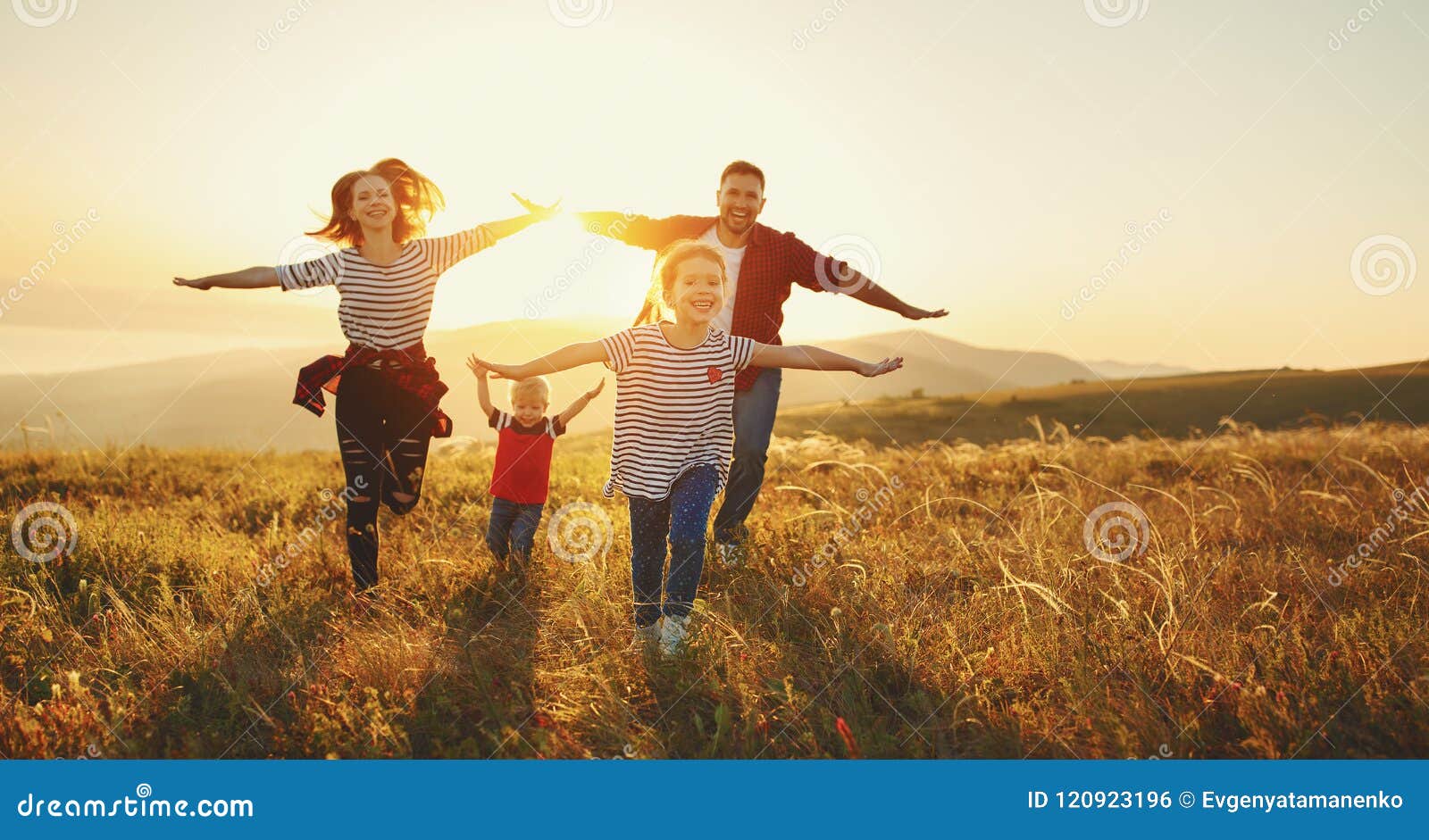 happy family: mother, father, children son and daughter on sunset