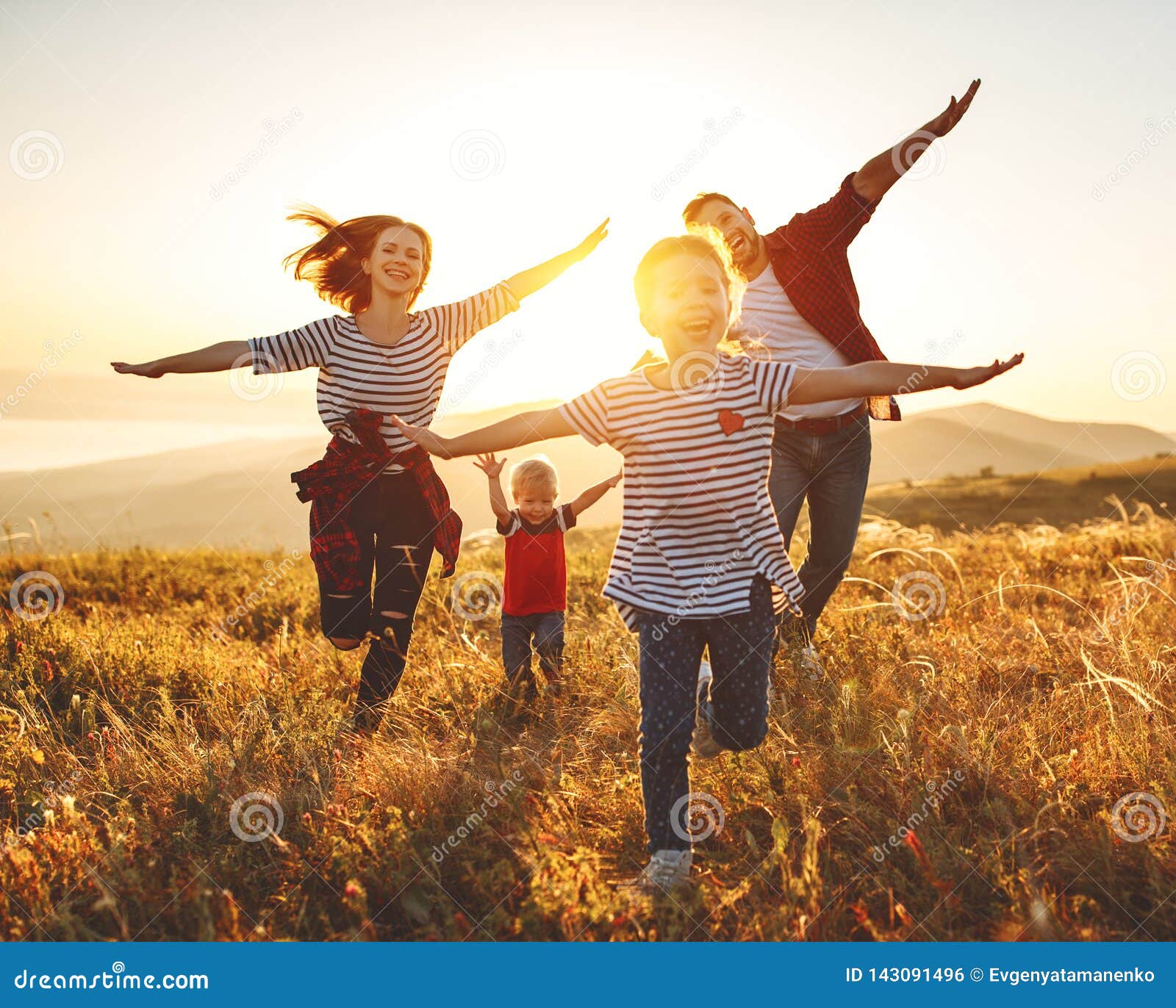 happy family: mother, father, children son and daughter on sunset