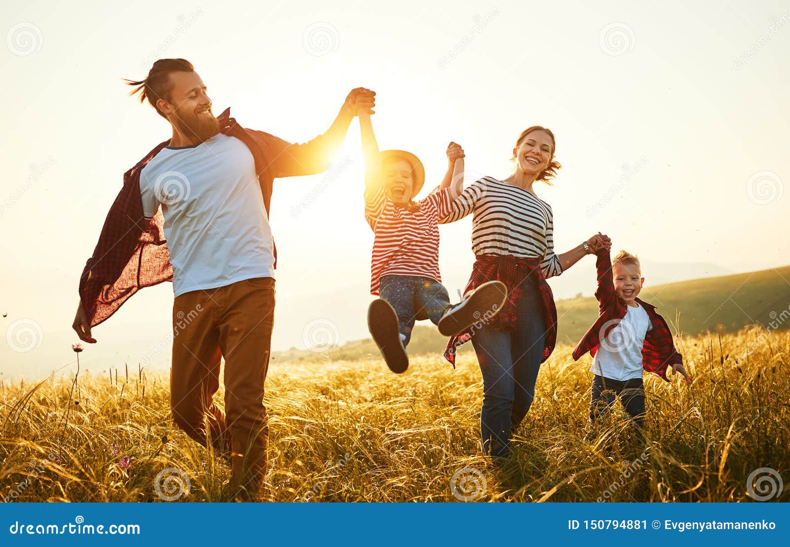happy family: mother, father, children son and daughter on sunset
