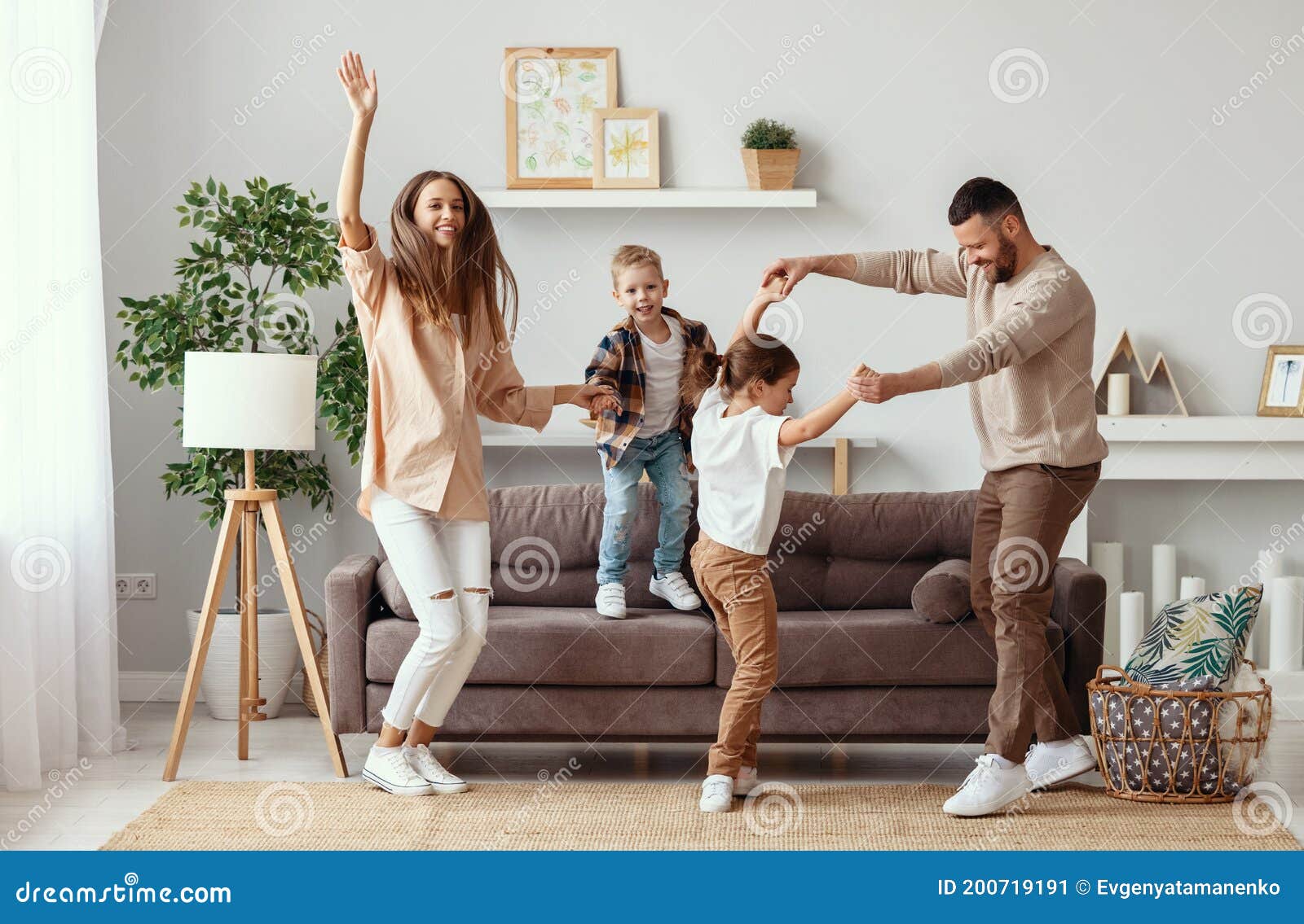 happy family mother father and children dancing at home