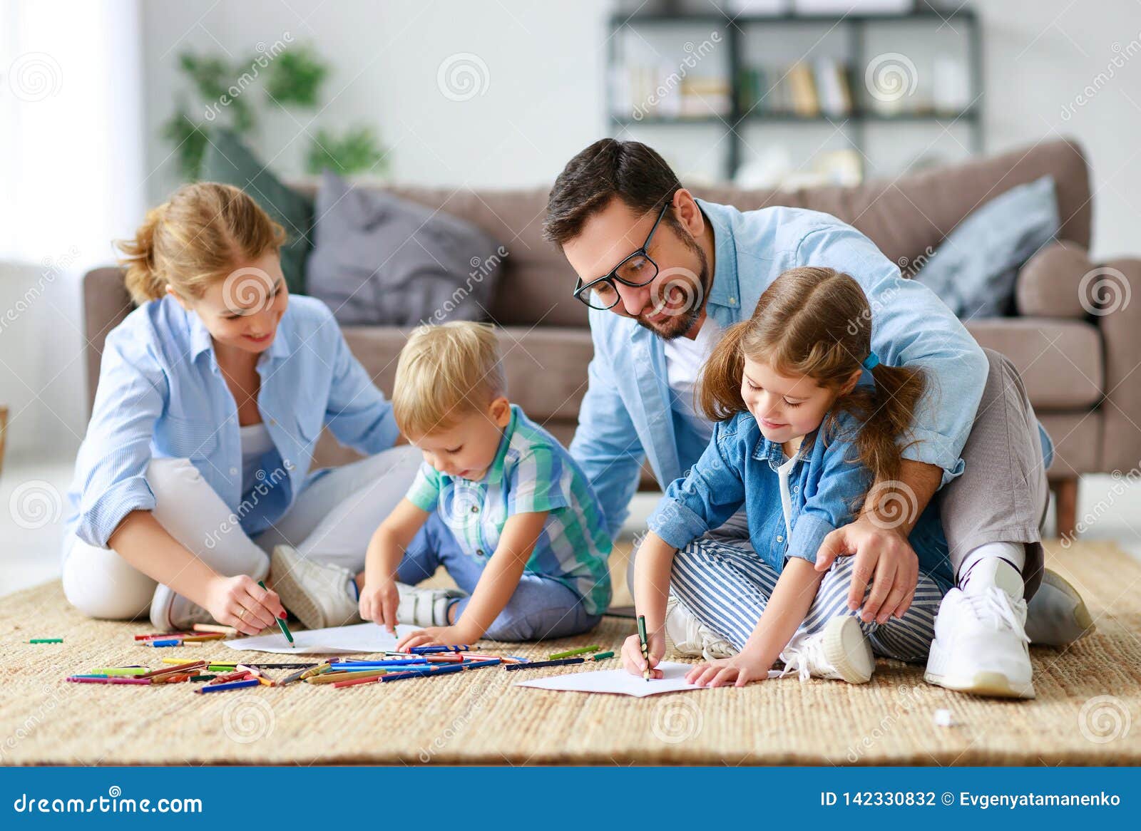 happy family mother father and kids draw together at home