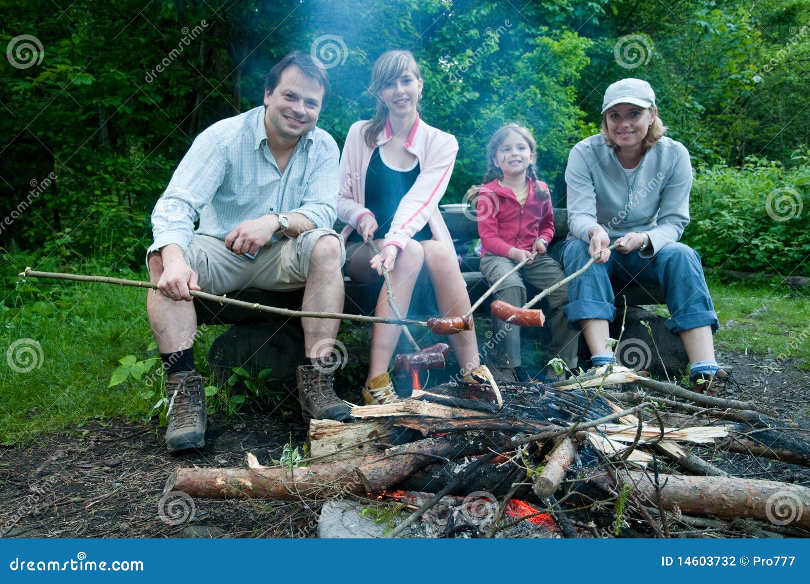 Happy family near campfire stock photo. Image of sister 14603732