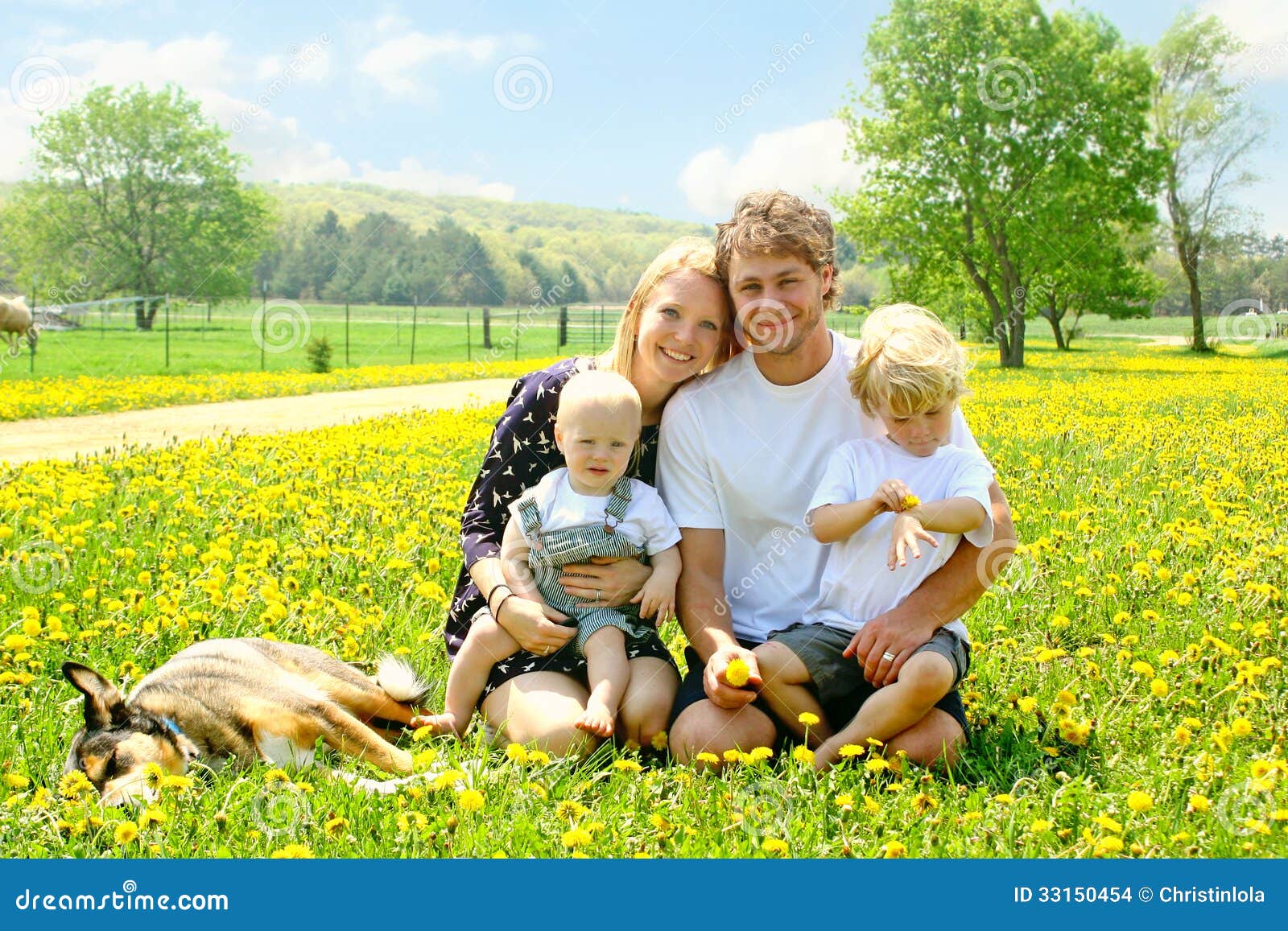 happy family outside in dandelions