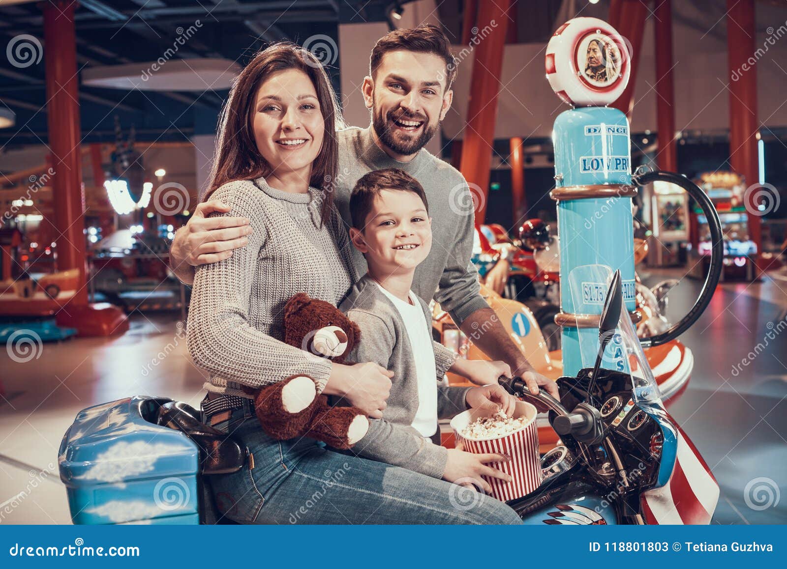 Happy Family Sitting On Toy Motorbike With Popcorn Editorial Stock