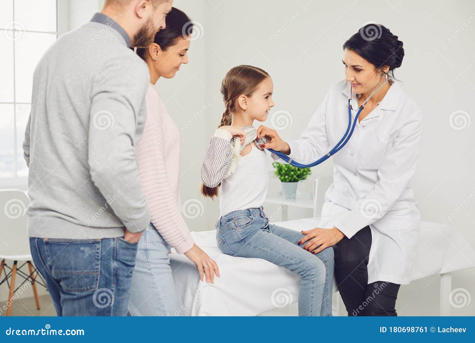 The Family Doctor Is Going To Resign Happy Family on a Visit To the Doctor in the Office of a Doctor. Stock