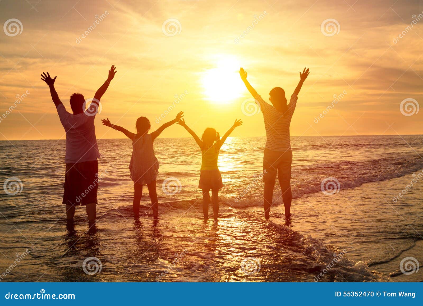 happy family watching the sunset on the beach