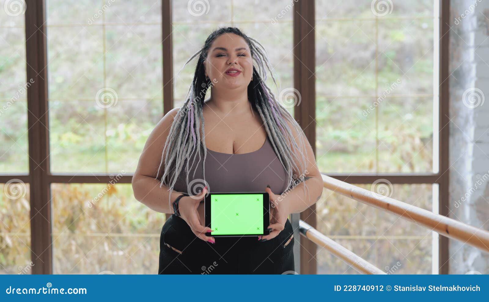 Happy Fat Woman in Underwear with Drearlocks Holding Green Screen
