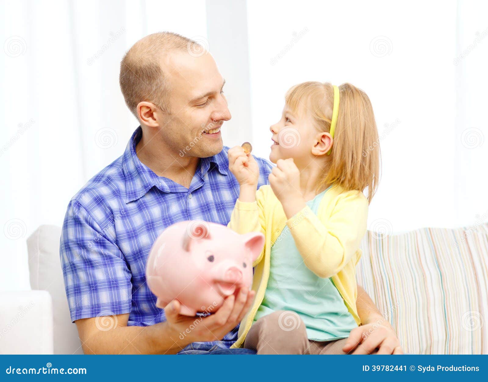 Happy father and daughter with big piggy bank. Family, children, money, investmen and happy people concept - happy father and daughter with big pink piggy bank