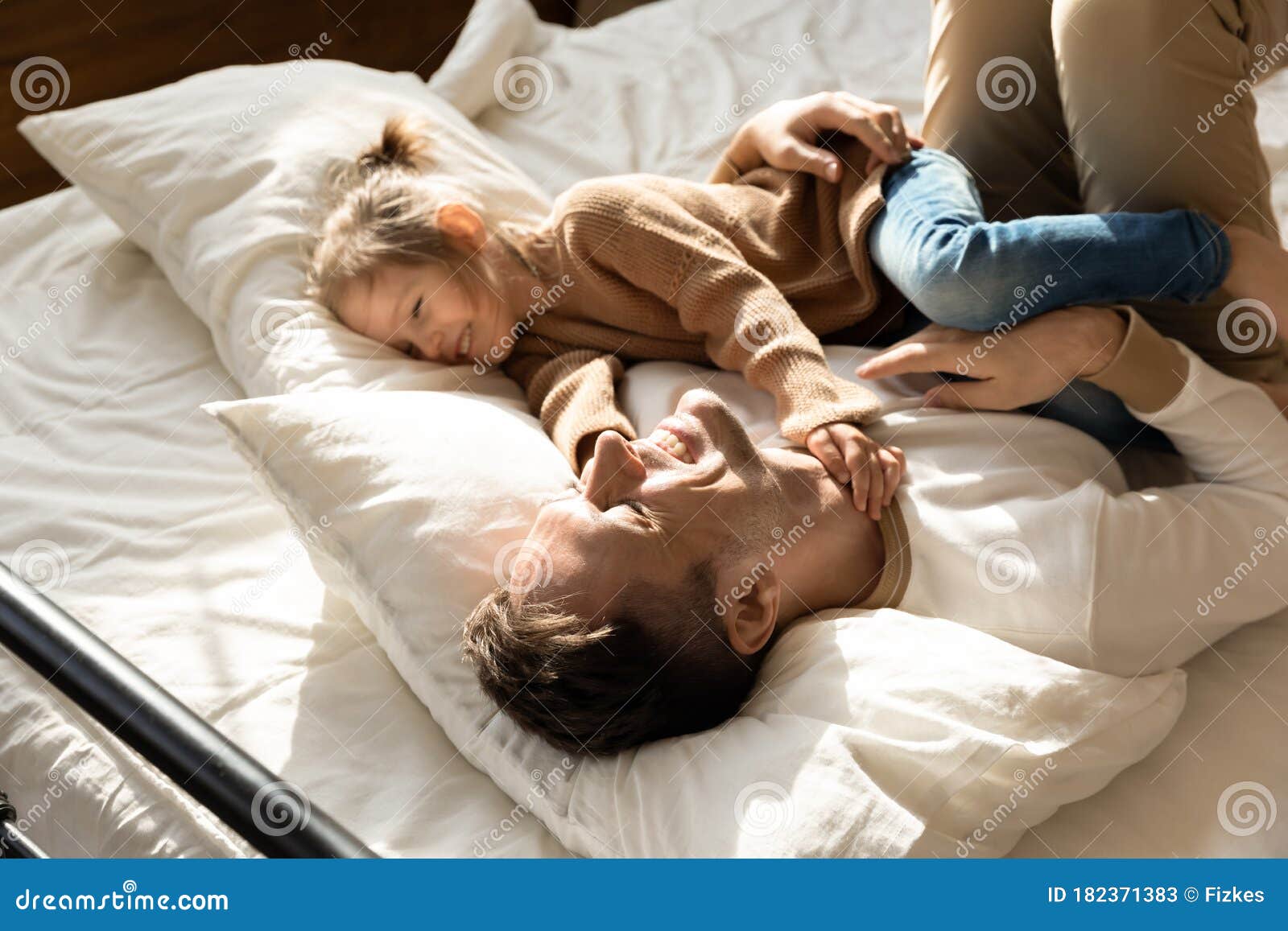 Happy Father And Little Daughter Relaxing In Cozy Bed Stock Image ... pic picture image