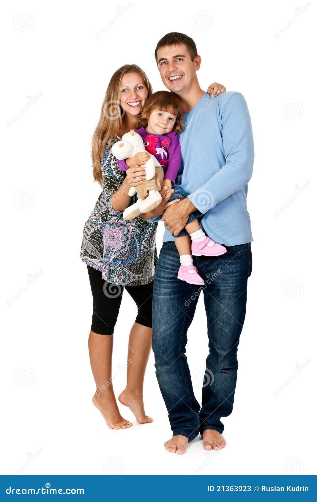 Happy father, mother and daughter in the studio barefoot on a white background
