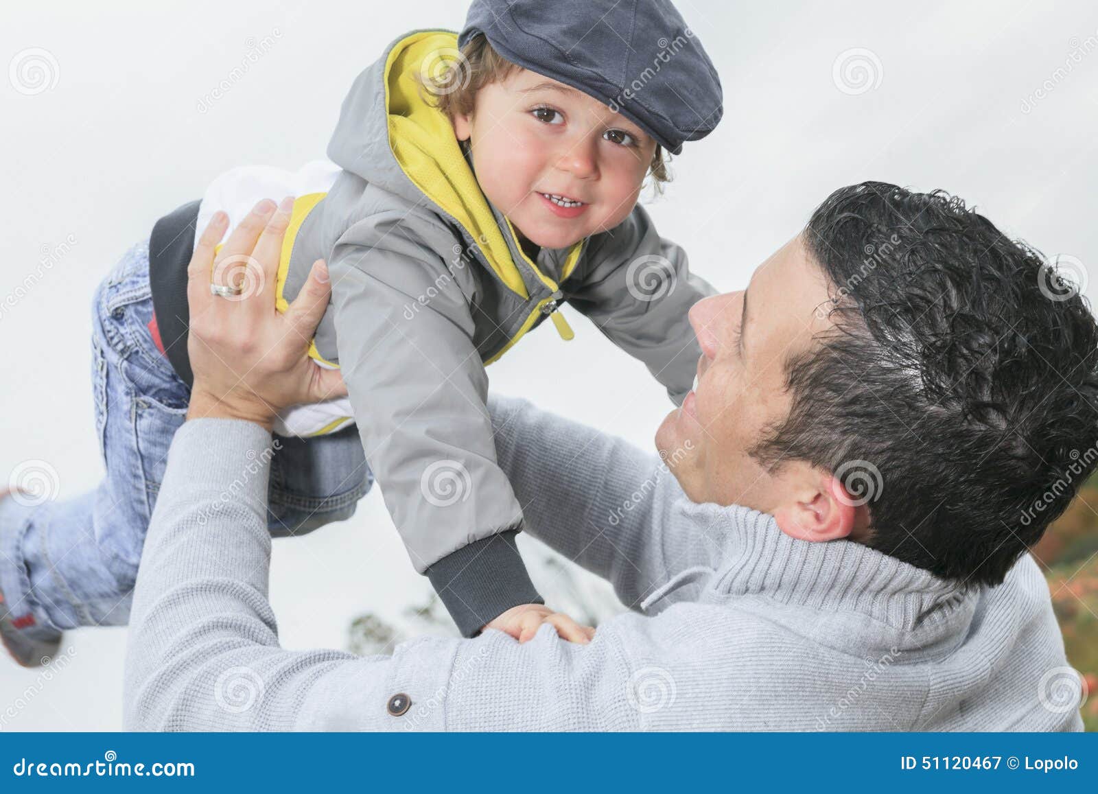 Happy Father and Son Having Fun Throws Up in the Stock Image Image of