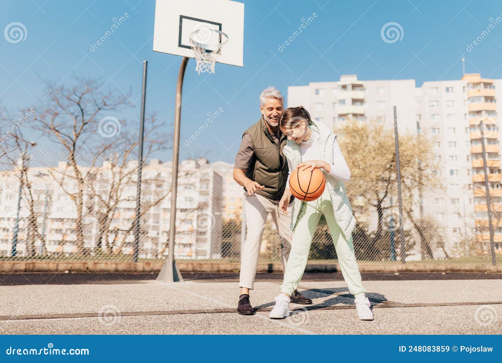 Happy Father And Teenage Daughter Playing Basketball Outside At Court Stock Image Image Of