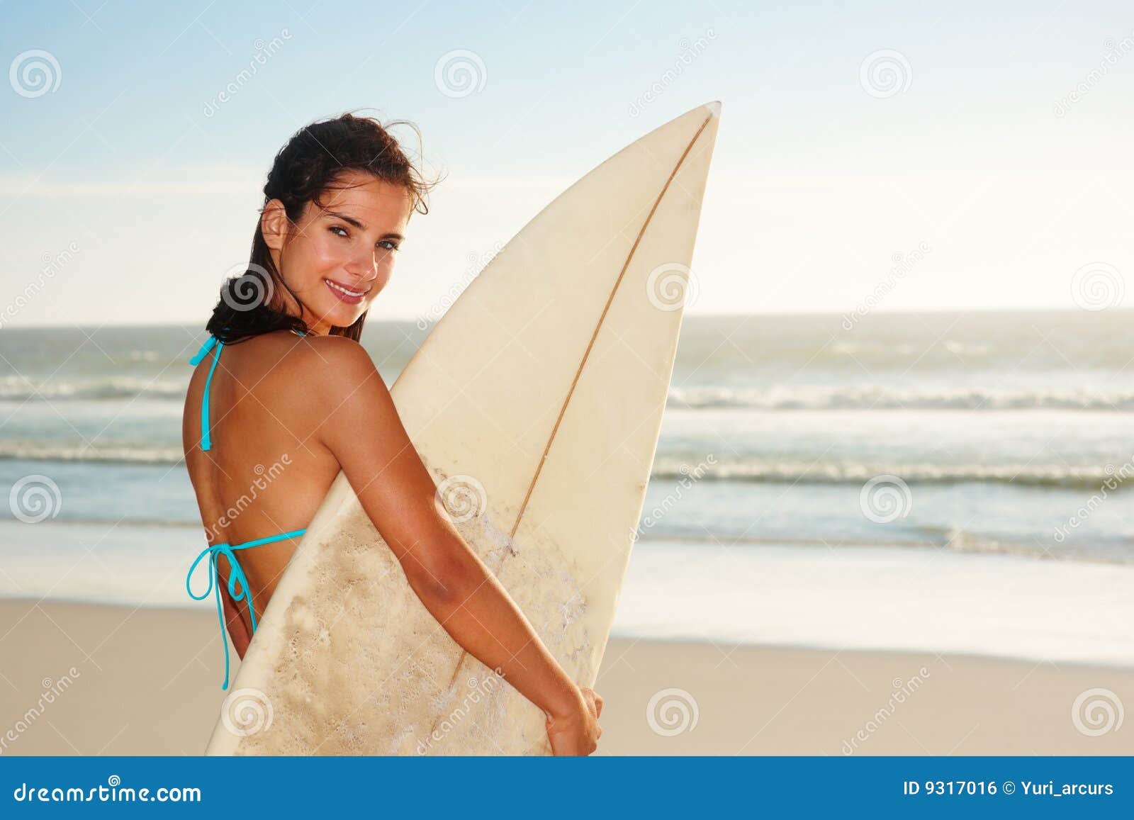 Happy Female Holding A Surf Board At The Sea Shore Stock