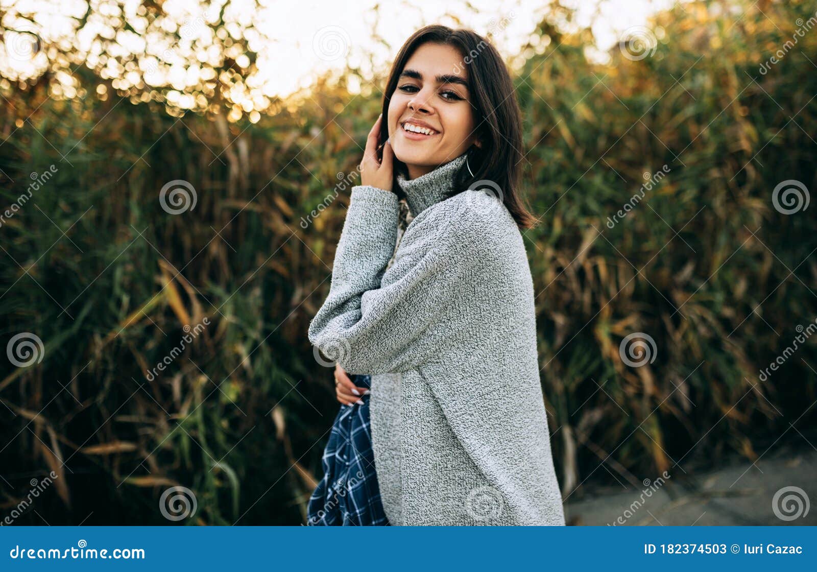 Happy Female Posing On Greenery Background, Looking At The Camera Has ...