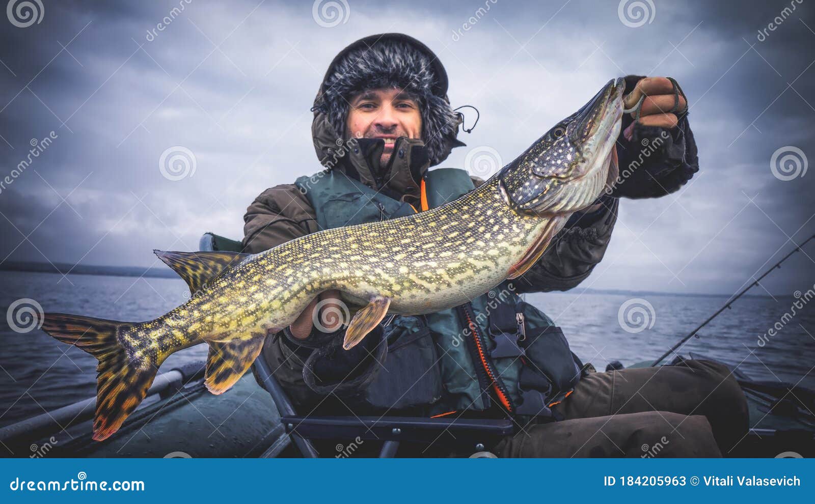 Happy Fisherman with Big Beautiful Pike in Hand. Fishing Stock
