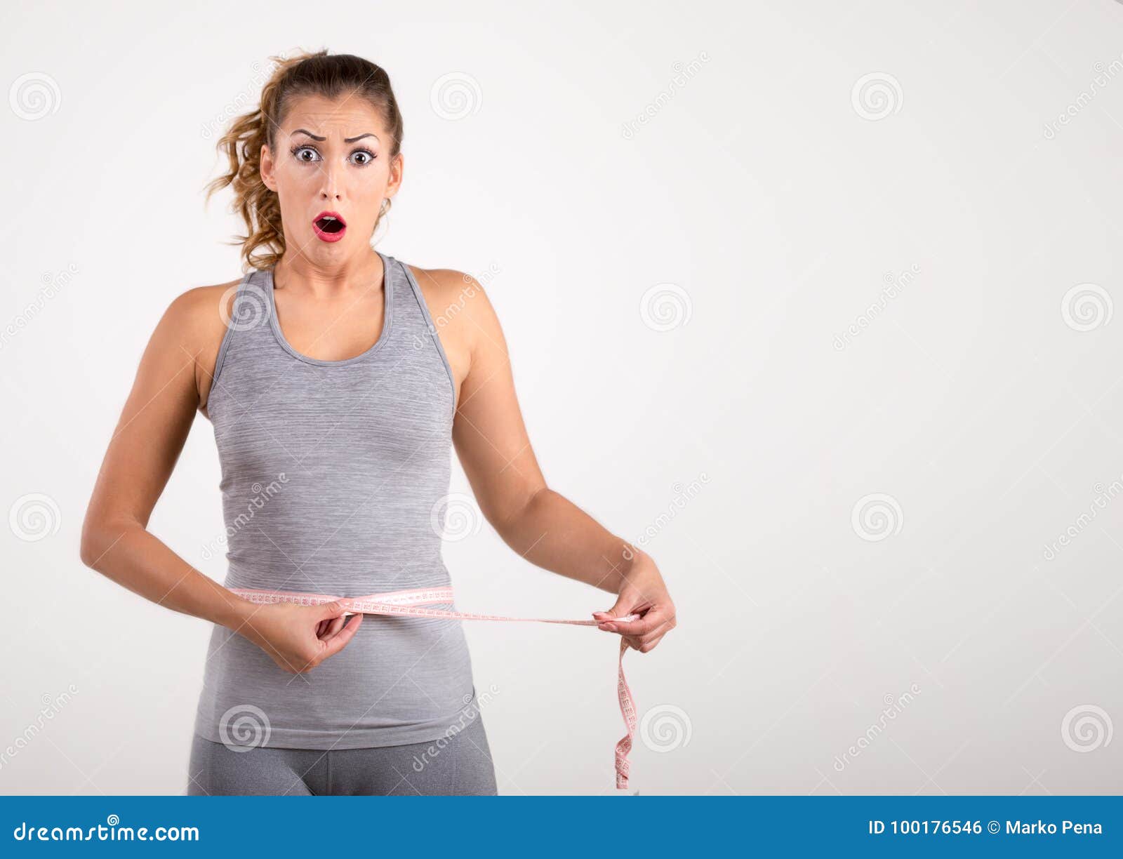 happy fitness girl measuring her waist with tape measure stock photo measure for weight loss