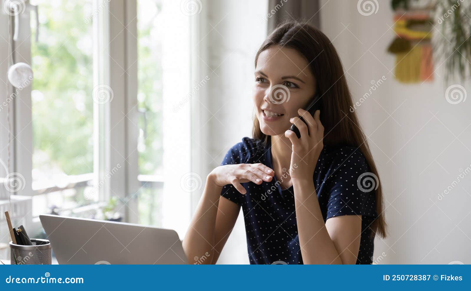 Happy Freelance Worker Woman Answering Telephone Call in Home Office