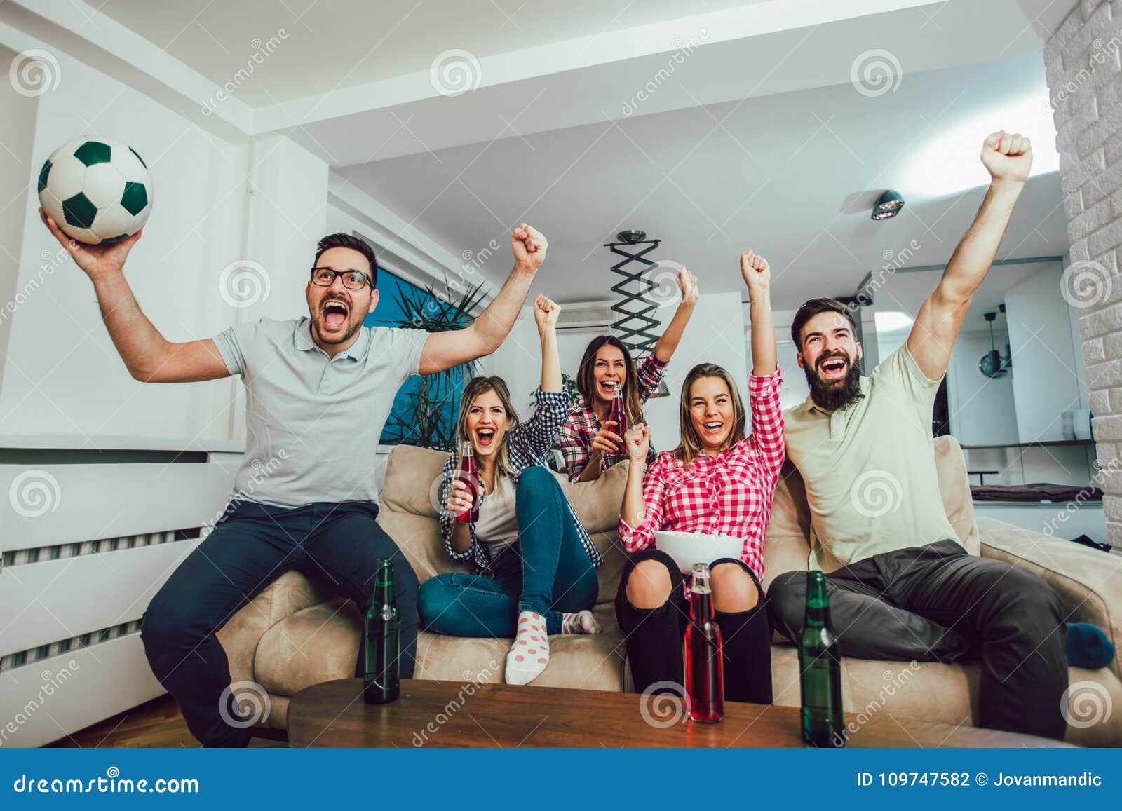 Happy Friends or Football Fans Watching Soccer on Tv Stock Photo