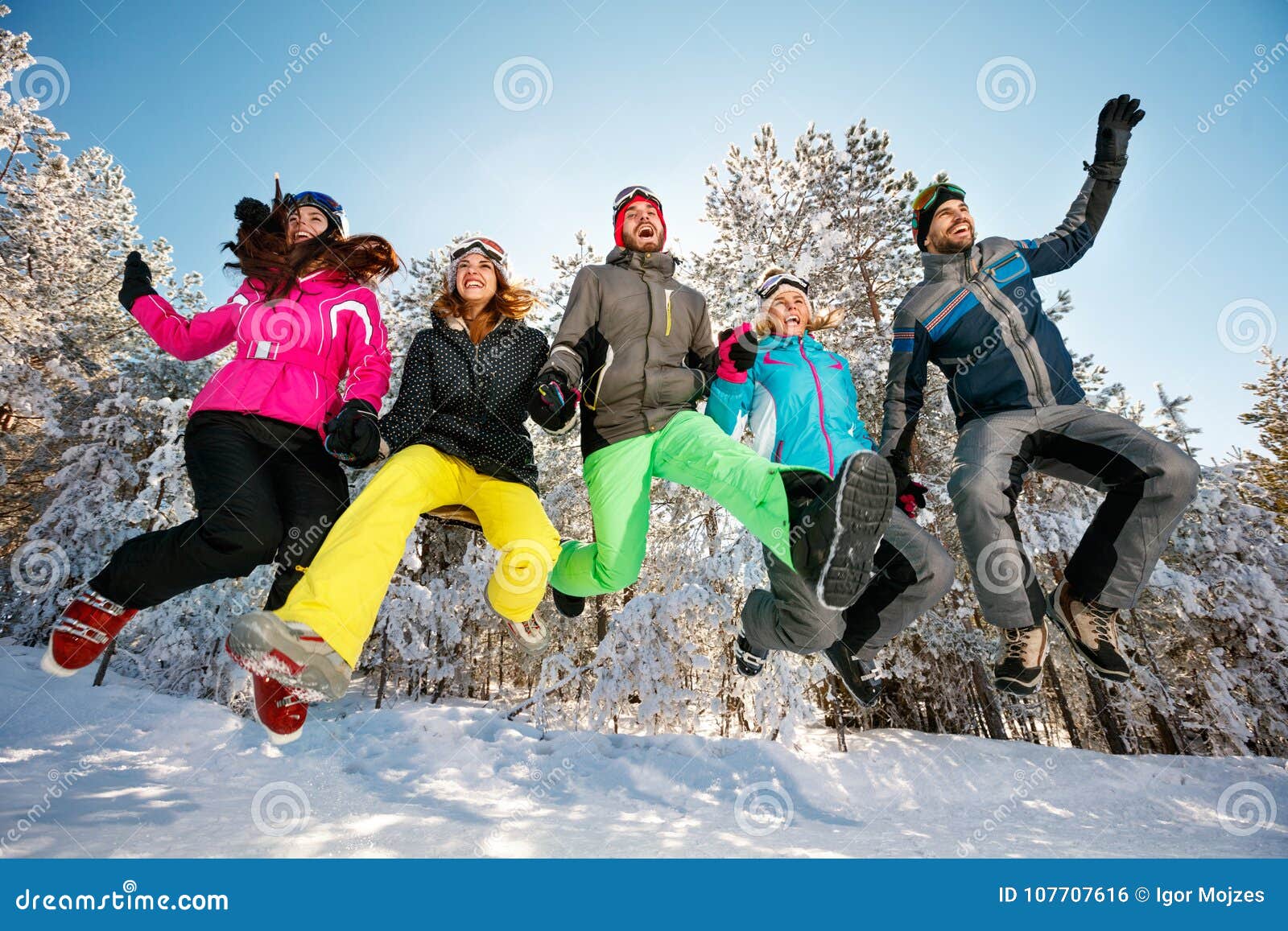 Happy Friends Jumping in the Snow Stock Photo - Image of forest ...