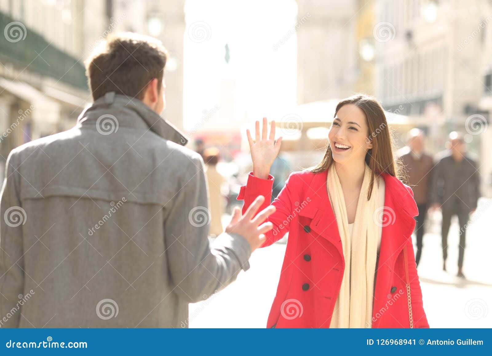 happy friends meeting and greeting in the street