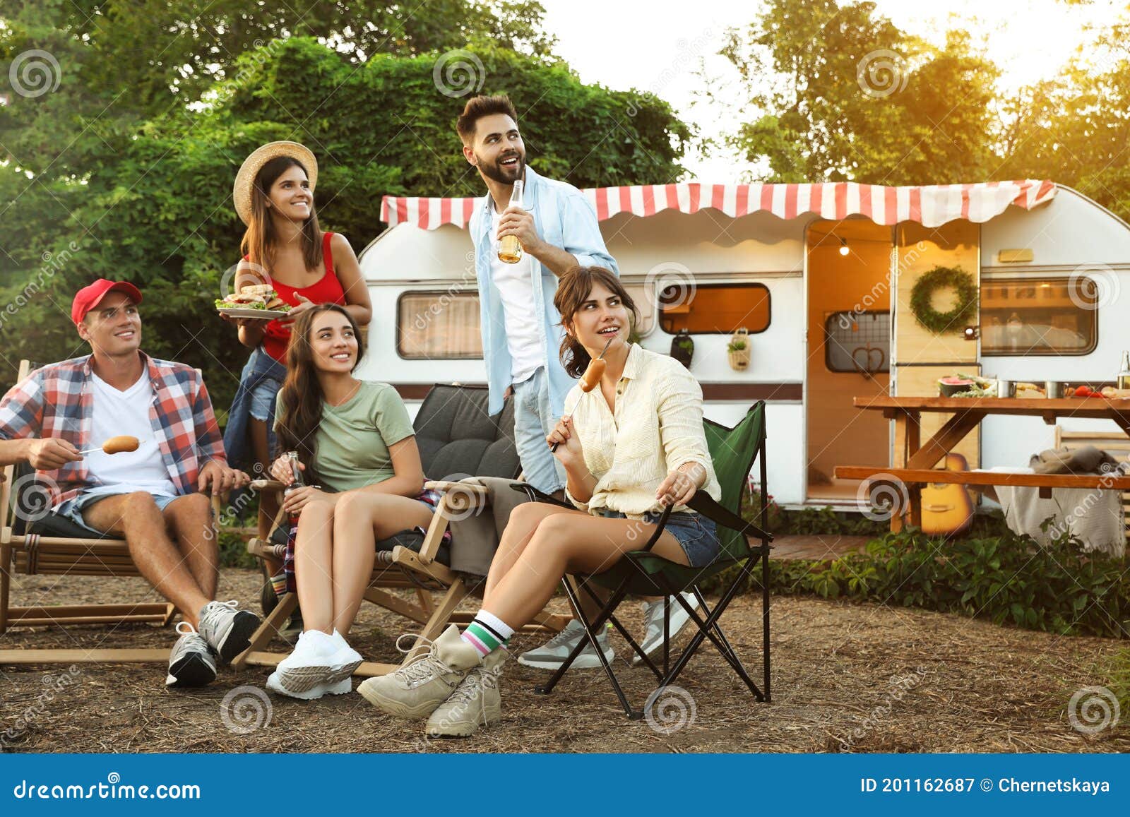 Happy Friends Resting Near Trailer. Camping Season Stock Image - Image ...