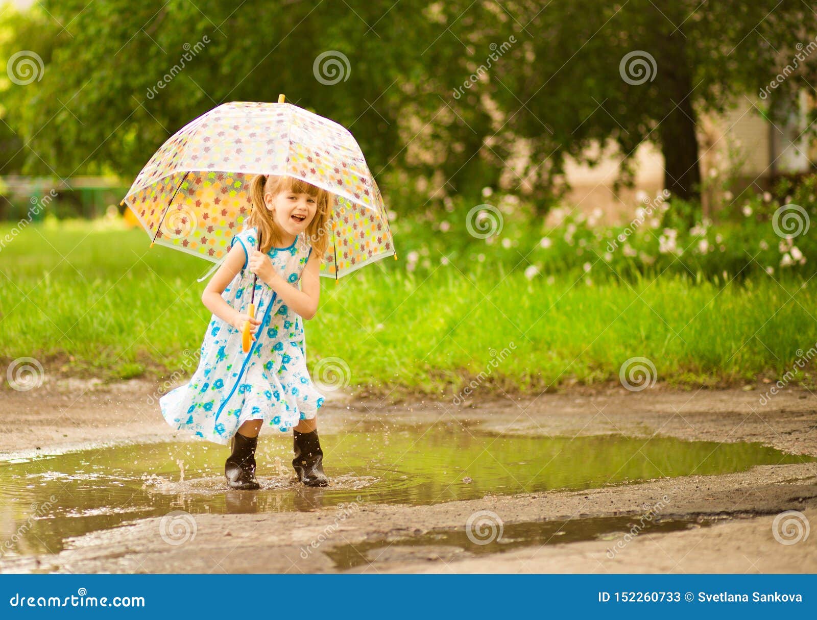 Happy Funny Kid Girl with Umbrella Jumping on Puddles in Rubber Boots ...