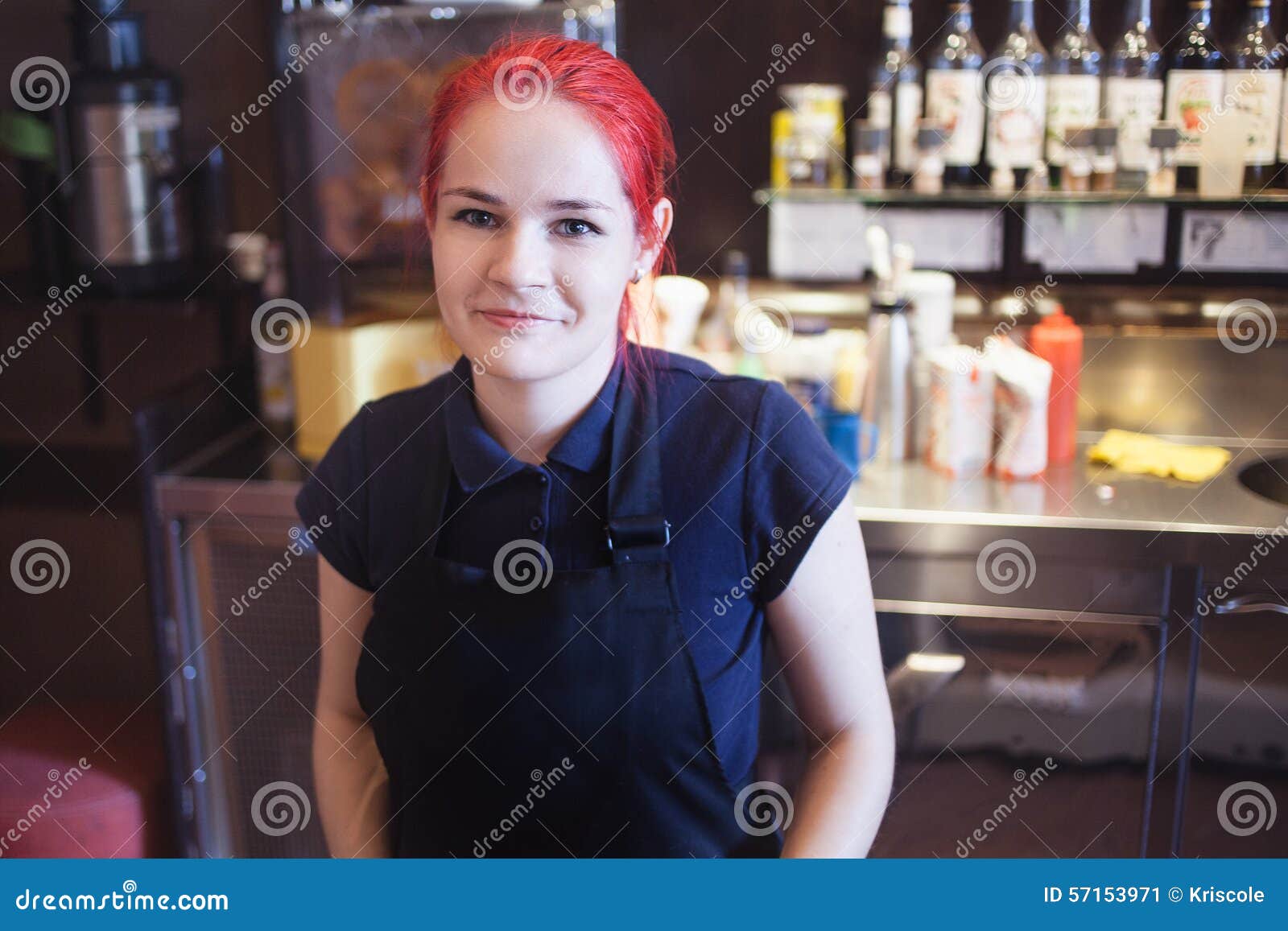 Happy girl Barista gives coffee to the customers