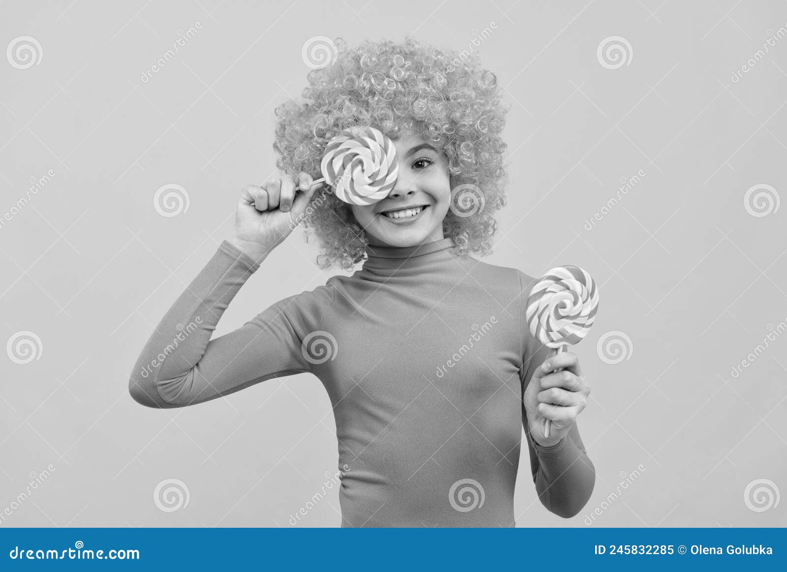 happy girl child with orange hair in pink poloneck have fun holding lollipops, girlhood