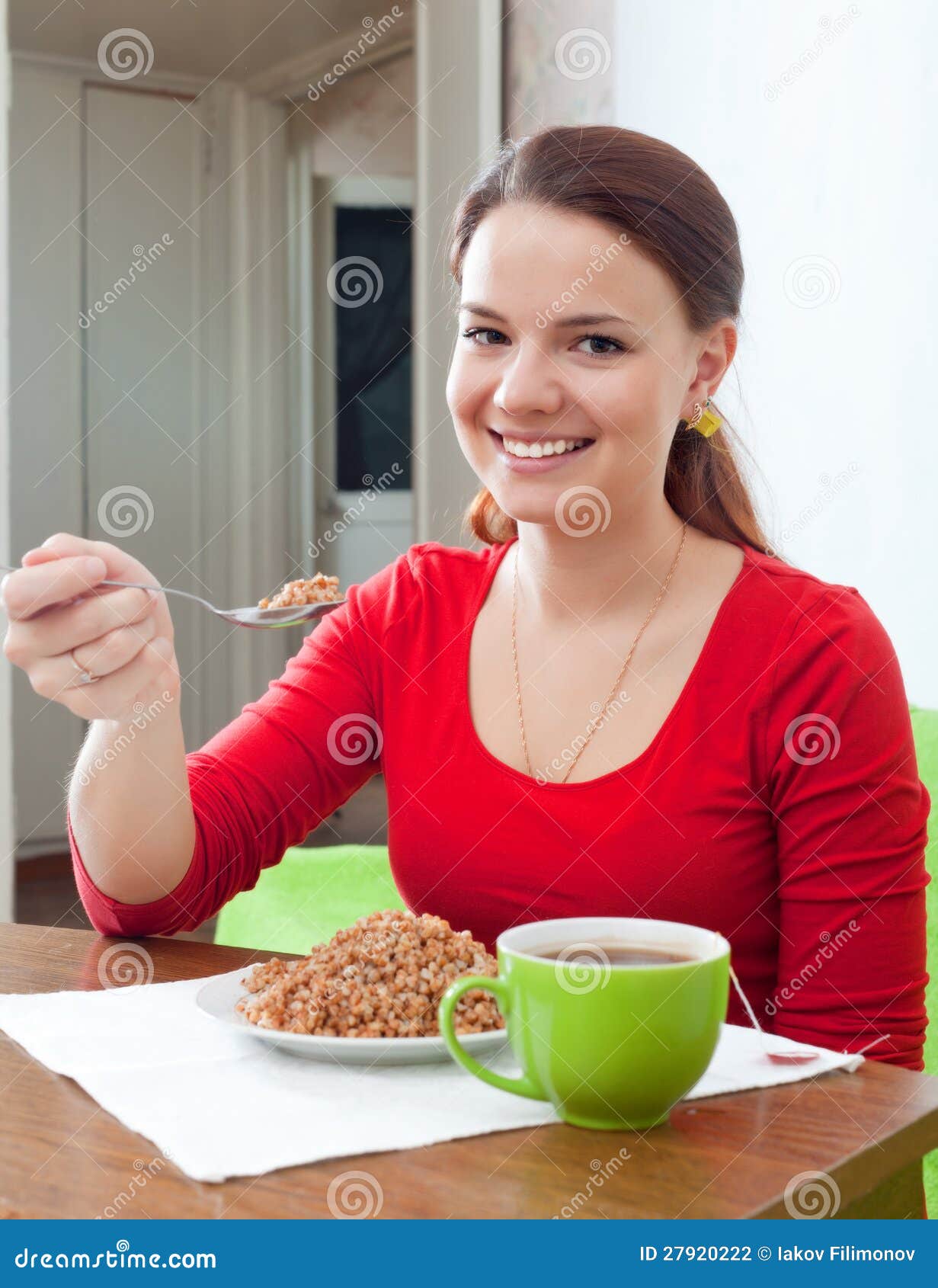 Happy Girl Eats Buckwheat at Home Stock Photo Image of indoors