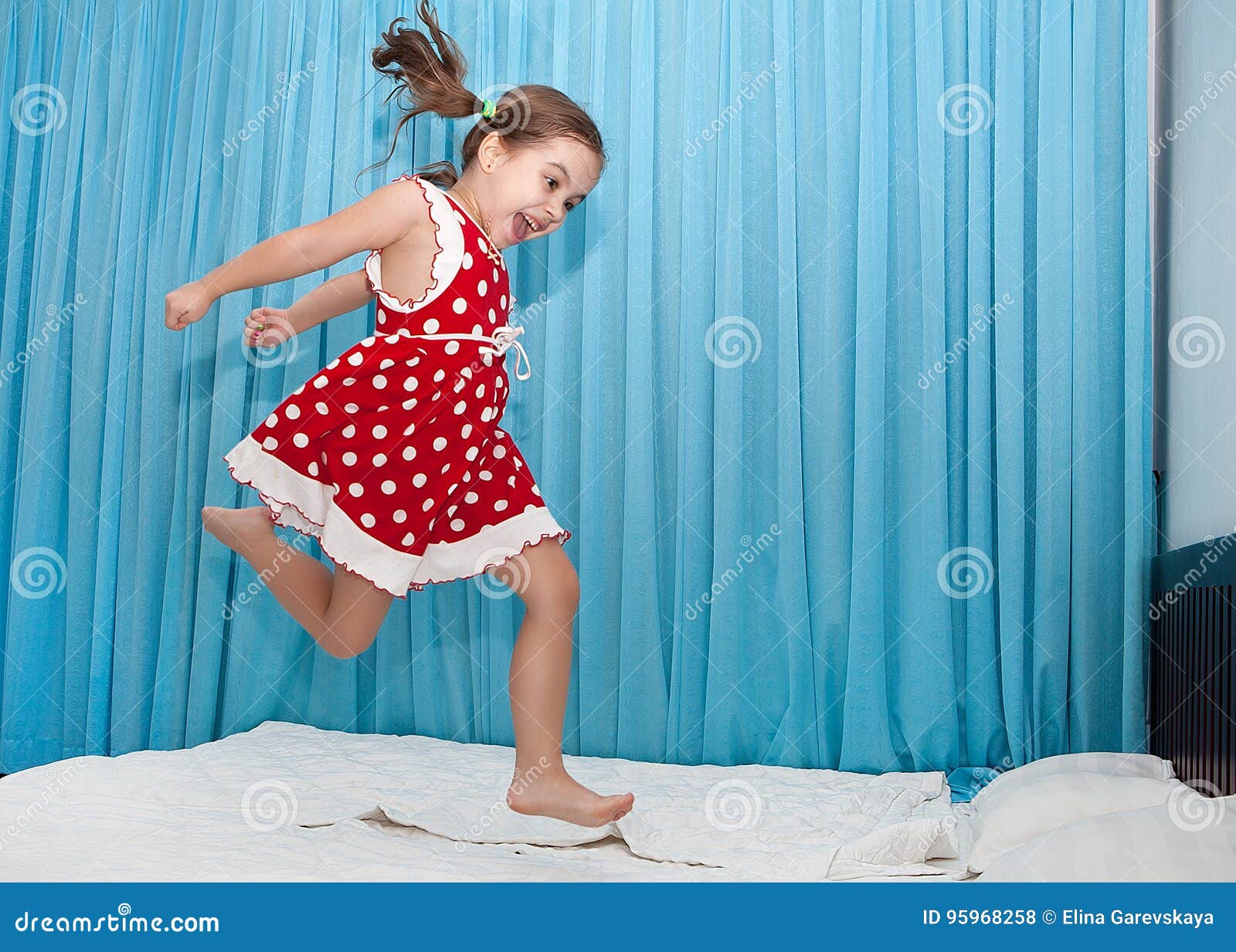 Happy Girl Jumping on the Bed Stock Photo Image of leisure, enjoyment 95968258