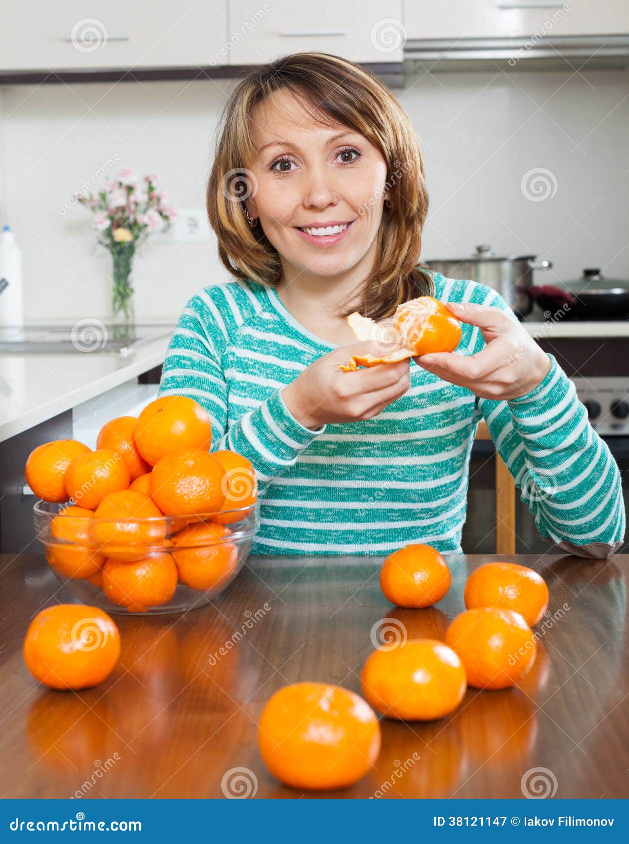 Happy girl with mandarins stock image. Image of diet 38121147