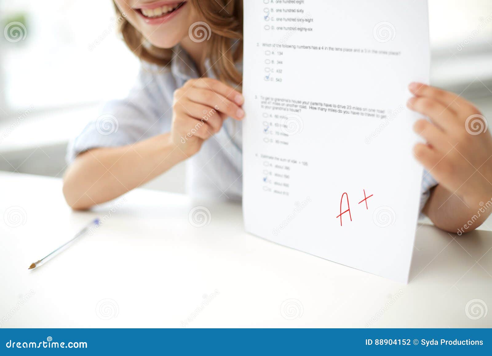 Education, people, children and learning concept - happy girl with test paper at school